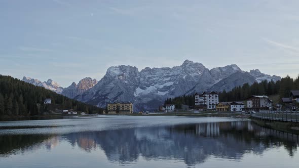 Sunset over Misurina Lake with sky reflection in calm water. 