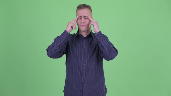 Portrait of Stressed Businessman Having Headache