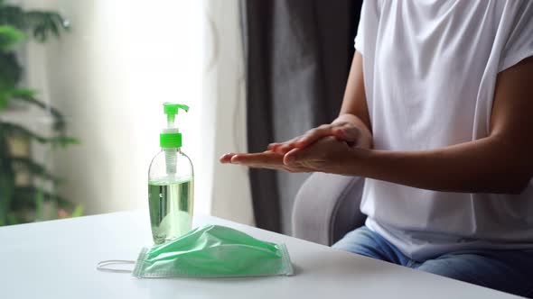 Young woman using alcohol gel sanitizer pump to avoid infections corona virus and bacteria