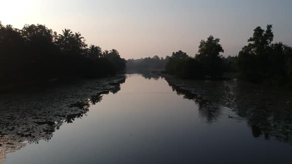 River in Asia,backwater village,Sunrise,Mist,irrigation,Boat,sunlight,morning shot