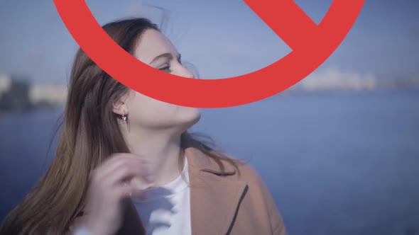 Close-up Portrait of Young Caucasian Woman Touching Face Outdoors As Prohibition Sign Appearing