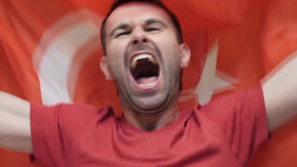 Turkish Fan Celebrates Holding the Flag of Turkey