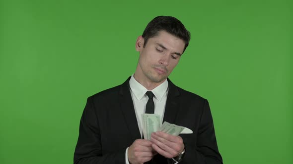 Businessman Counting Money and Putting in Pocket Chroma Key