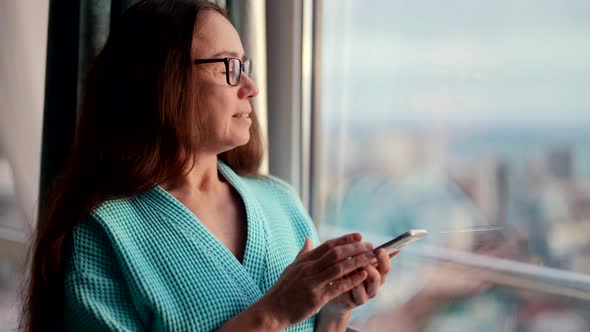 Joyful Woman is Chatting Online in App of Smartphone Using Social Media and Laughing