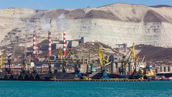 Harbor Cranes Loading Coal Next to a Quarry