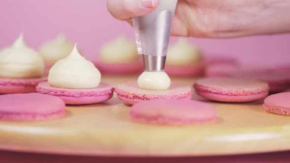 Beautiful Pink Macaroons on Fill with Light Cream on a Pink Background