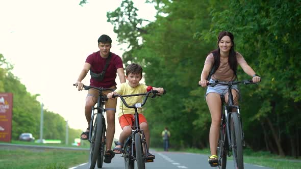 Fit family on bike ride on summer day