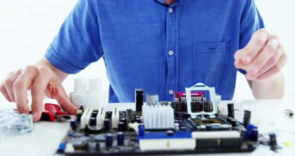 Computer engineer repairing computer motherboard