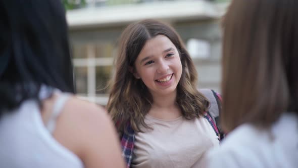 Portrait of Charming Beautiful Teenage Girl Meeting Friends on City Street Talking Smiling