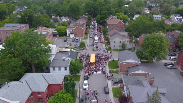 Aerial zoom out of People celebrating Pride Day with a Parade
