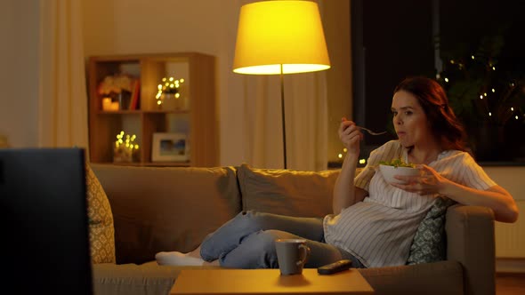 Happy Smiling Pregnant Woman Watching Tv at Home