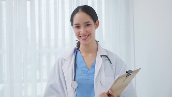 Portrait of beautiful physician doctor wear gown sit on sofa in house.