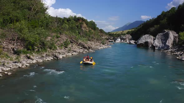 group paddling down the wild Vjosa river in Permet, Albania. Aerial, tracking view