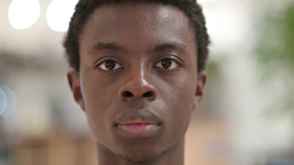 Close Up of Young African Man Looking at the Camera