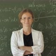 Teacher Portrait in the Classroom on Blackboard Background - VideoHive Item for Sale