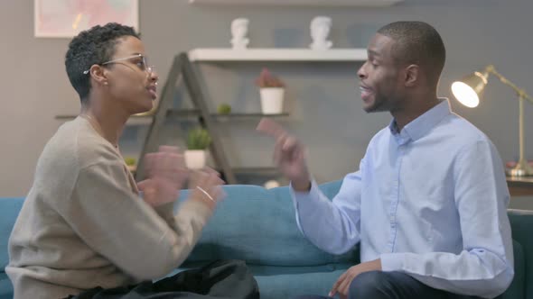 Angry African Man Fighting with African Woman on Sofa