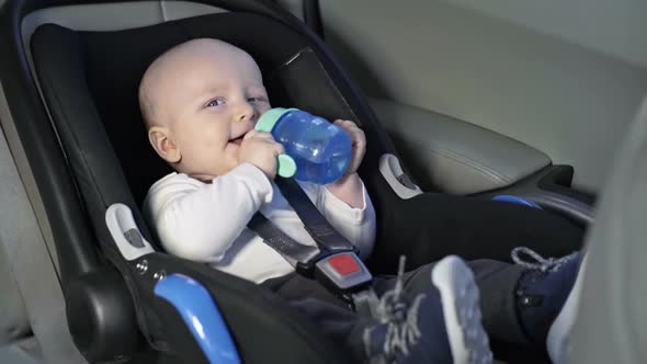 Baby Drinking Water in Car Seat