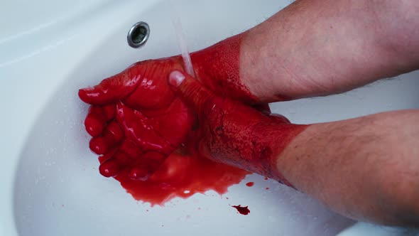 Faceless Man Washing Hands From Red Liquid Blood