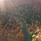 Aerial flythrough of Winding Road Through Autumn Trees with Fall Colors in New England - VideoHive Item for Sale