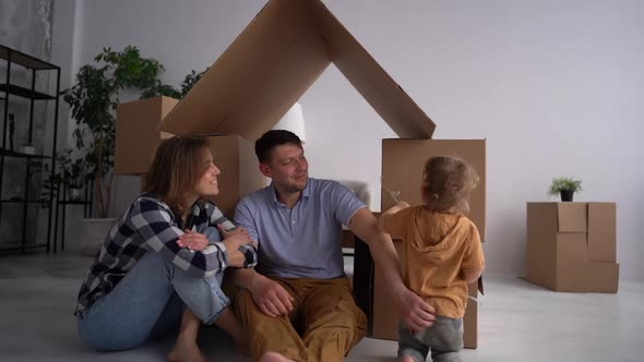 A Portrait of Young Family with a Toddler Boy Moving in New Home