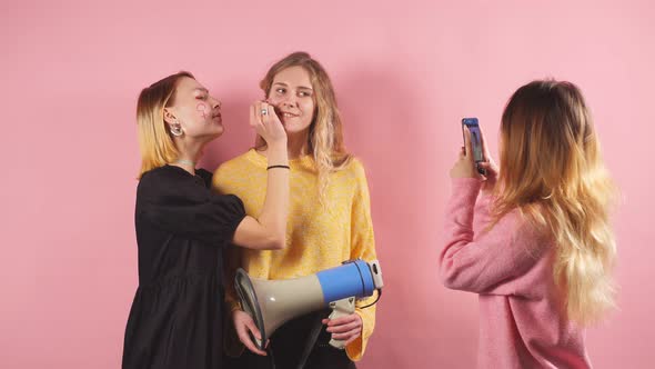 Three Young Women in Blouses Are Going To Fight for Women's Rights, Isolated in the Studio