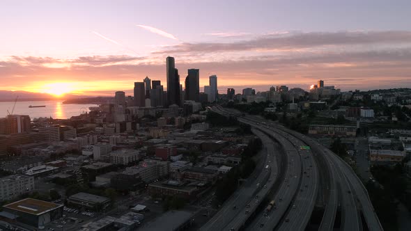 Helicopter Aerial Of Seattle City Skyline With Red Lens Flare From Glowing Sunset