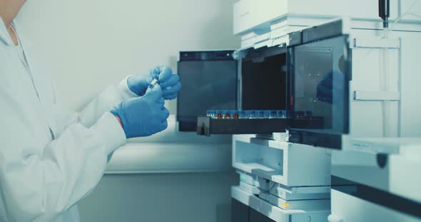 Laboratory Technician working with small bottles