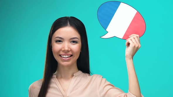 Beautiful Woman Holding French Speech Bubble, Foreign Language Courses, Travel