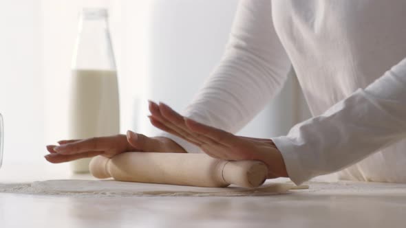 Close Up of Unrecognizable African American Woman Rolling Dough with Wooden Pin Preparing Homemade