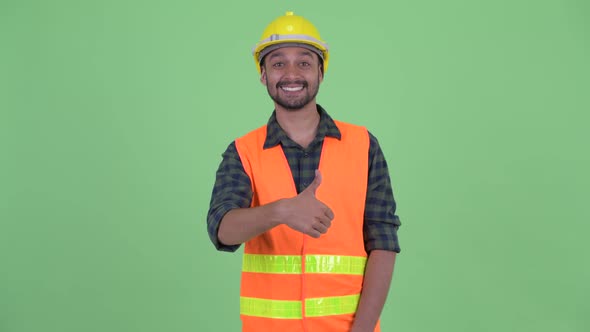 Happy Young Bearded Persian Man Construction Worker Giving Thumbs Up