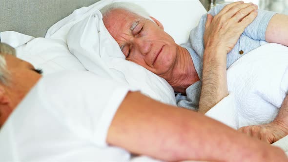 Senior couple sleeping in the bedroom