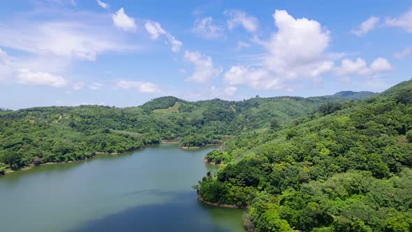 Aerial view Drone Hyperlapse shot of Tropical landscape rainforest with clouds flowing over mountain