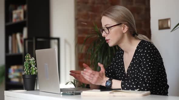 beautiful woman working on her laptop in home office