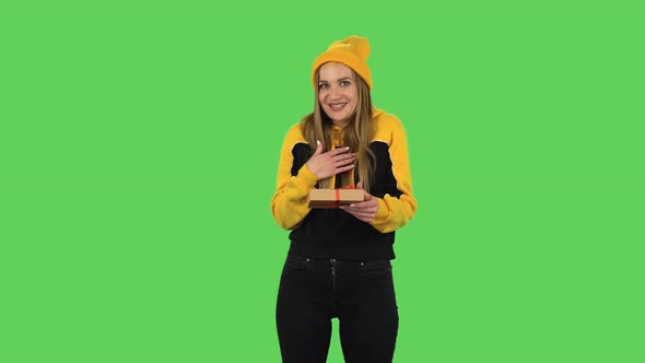 Modern Girl in Yellow Hat Is Opening the Gift, Very Surprised and Upset. Green Screen