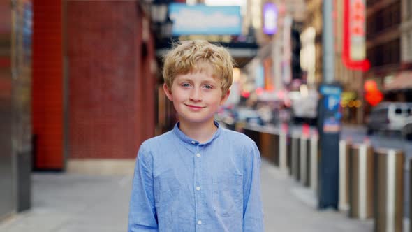 Blond Boy In Blue Walking Along New York City Street