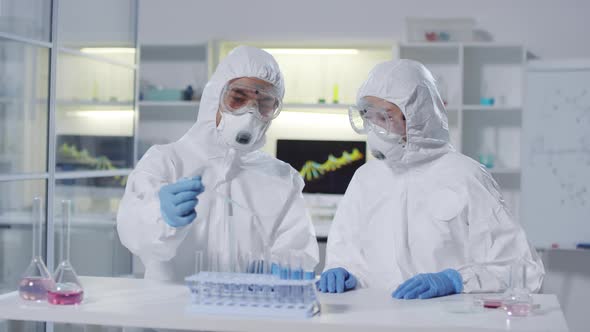 Chemists in Protective Gear Working in Laboratory