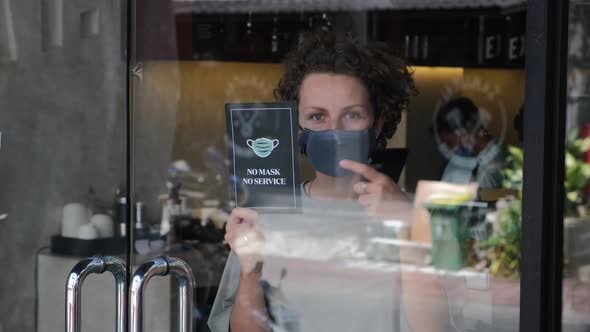 Woman Pointing on the No Mask No Service Poster in Cafeteria Door Coronavirus Protection Measures