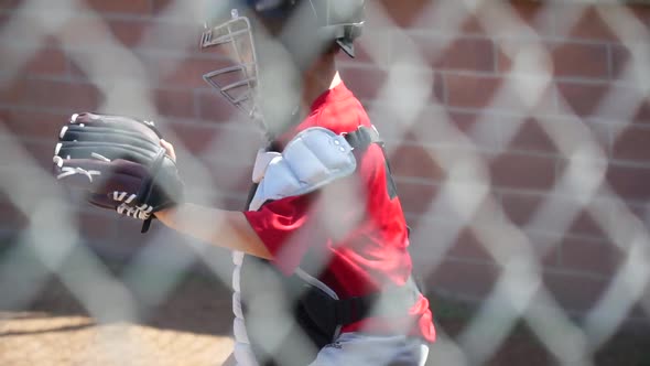 Close-up of a boy playing catcher for a little league baseball team.