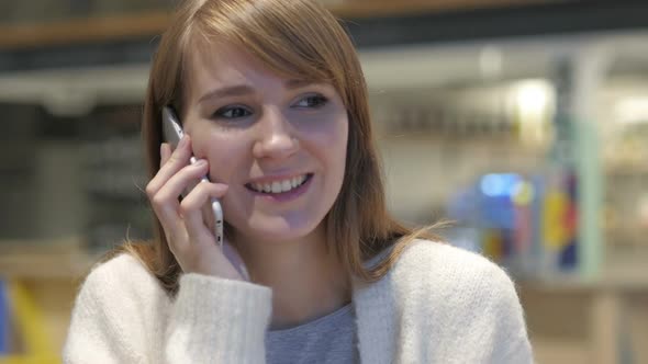 Young Woman Talking on Phone Attending Phone Call