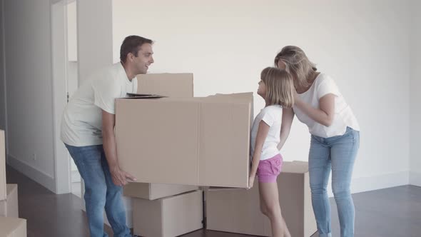 Cheerful Dad and Daughter Carrying Cartoon Box