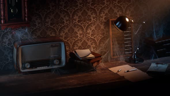Old dark room with vintage desk and chair.  Cobwebs on radio, books and abacus.