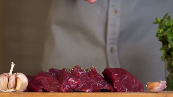 Piece of Raw Meat Sprinkled with Spices and Pepper