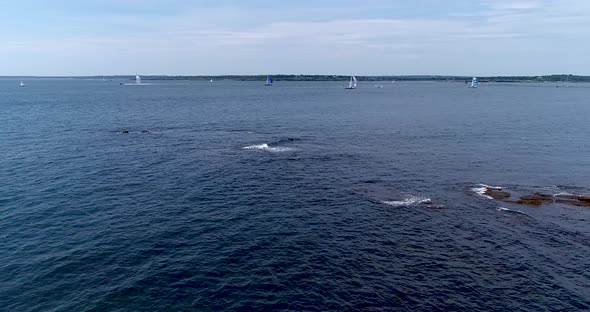 Sailboats entering and leaving Mt. Hope Bay in Newport Rhode Island as well as returning from Block