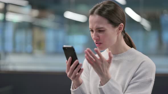 Woman having Loss while using Smartphone