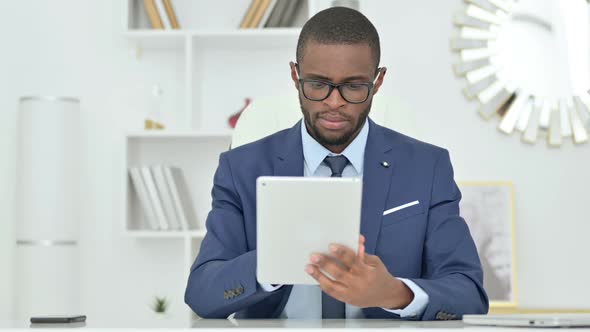 Portrait of Serious African Businessman Using Digital Tablet