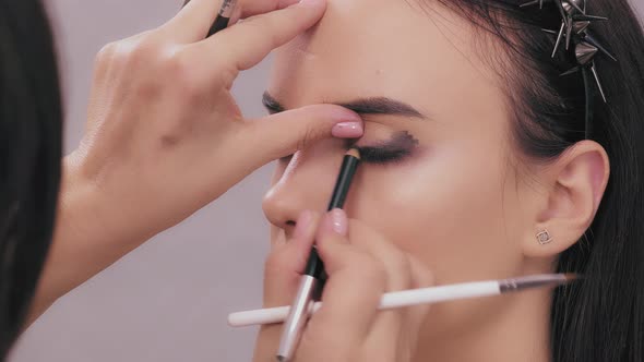 Stylist Make-up Artist Makes Eye Makeup Model