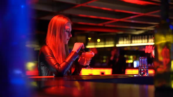 Man Hesitates to Get Acquainted With Pretty Woman Sitting Alone at Bar Counter