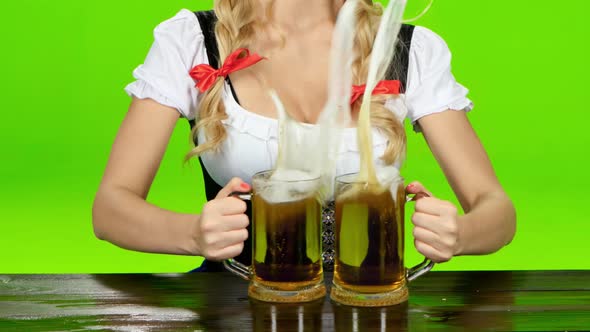 Woman in Bavarian Costume Puts the Glasses with Beer. Green Screen. Close Up