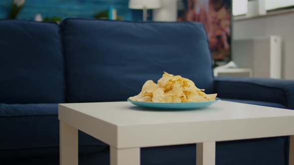 Chips Snack Sitting on Coffe Table in Front of Cozy Sofa