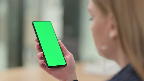 Rear View of Businesswoman Holding Smartphone with Chroma Screen 